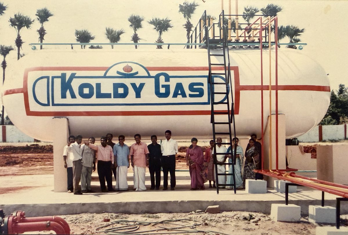 The team in front of the storage vessel at the first plant, 1995